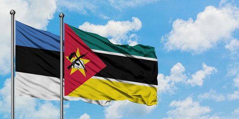 Estonia and Mozambique flag waving in the wind against white cloudy blue sky together. Diplomacy concept, international relations.