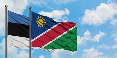 Estonia and Namibia flag waving in the wind against white cloudy blue sky together. Diplomacy concept, international relations.