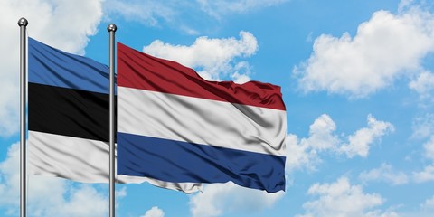 Estonia and Netherlands flag waving in the wind against white cloudy blue sky together. Diplomacy concept, international relations.