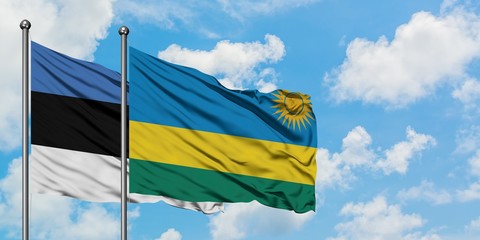 Estonia and Rwanda flag waving in the wind against white cloudy blue sky together. Diplomacy concept, international relations.