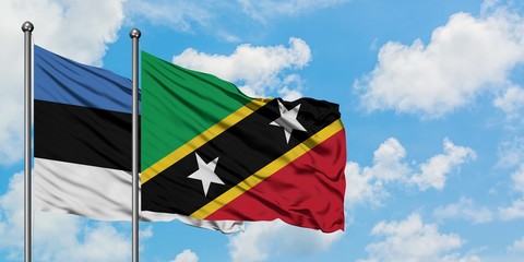 Estonia and Saint Kitts And Nevis flag waving in the wind against white cloudy blue sky together. Diplomacy concept, international relations.