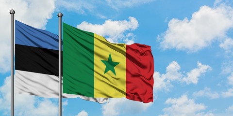Estonia and Senegal flag waving in the wind against white cloudy blue sky together. Diplomacy concept, international relations.