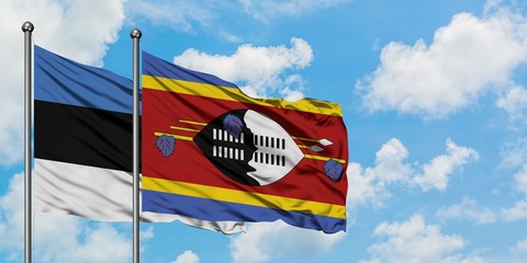 Estonia and Swaziland flag waving in the wind against white cloudy blue sky together. Diplomacy concept, international relations.