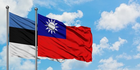 Estonia and Taiwan flag waving in the wind against white cloudy blue sky together. Diplomacy concept, international relations.