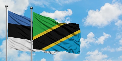 Estonia and Tanzania flag waving in the wind against white cloudy blue sky together. Diplomacy concept, international relations.