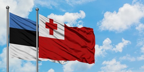 Estonia and Tonga flag waving in the wind against white cloudy blue sky together. Diplomacy concept, international relations.