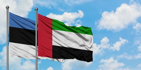 Estonia and United Arab Emirates flag waving in the wind against white cloudy blue sky together. Diplomacy concept, international relations.