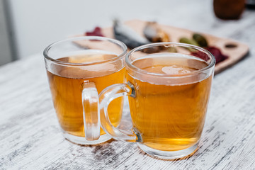 mugs with beer on the background of snacks