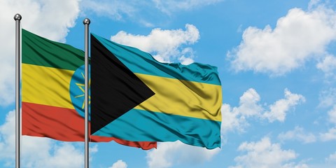 Ethiopia and Bahamas flag waving in the wind against white cloudy blue sky together. Diplomacy concept, international relations.