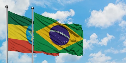 Ethiopia and Brazil flag waving in the wind against white cloudy blue sky together. Diplomacy concept, international relations.