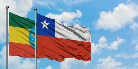 Ethiopia and Chile flag waving in the wind against white cloudy blue sky together. Diplomacy concept, international relations.