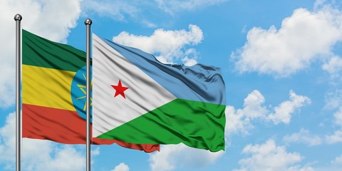 Ethiopia and Djibouti flag waving in the wind against white cloudy blue sky together. Diplomacy concept, international relations.