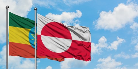 Ethiopia and Greenland flag waving in the wind against white cloudy blue sky together. Diplomacy concept, international relations.