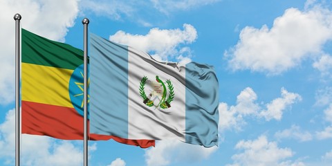 Ethiopia and Guatemala flag waving in the wind against white cloudy blue sky together. Diplomacy concept, international relations.