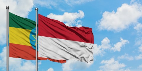 Ethiopia and Indonesia flag waving in the wind against white cloudy blue sky together. Diplomacy concept, international relations.
