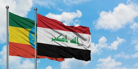 Ethiopia and Iraq flag waving in the wind against white cloudy blue sky together. Diplomacy concept, international relations.