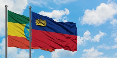 Ethiopia and Liechtenstein flag waving in the wind against white cloudy blue sky together. Diplomacy concept, international relations.