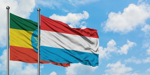 Ethiopia and Luxembourg flag waving in the wind against white cloudy blue sky together. Diplomacy concept, international relations.