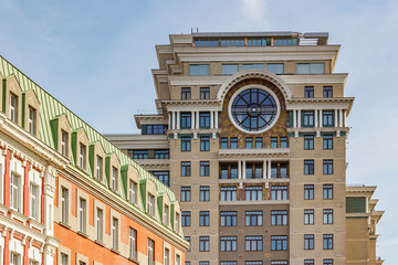 Tower of contemporary residential building in Moscow against blue sky at sunny day. Architecture of Moscow center