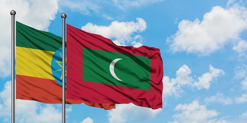 Ethiopia and Maldives flag waving in the wind against white cloudy blue sky together. Diplomacy concept, international relations.
