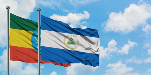 Ethiopia and Nicaragua flag waving in the wind against white cloudy blue sky together. Diplomacy concept, international relations.