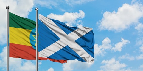 Ethiopia and Scotland flag waving in the wind against white cloudy blue sky together. Diplomacy concept, international relations.