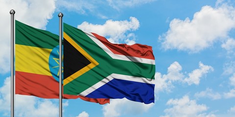 Ethiopia and South Africa flag waving in the wind against white cloudy blue sky together. Diplomacy concept, international relations.