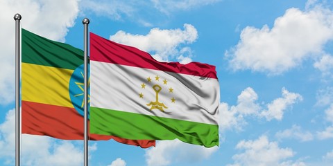 Ethiopia and Tajikistan flag waving in the wind against white cloudy blue sky together. Diplomacy concept, international relations.