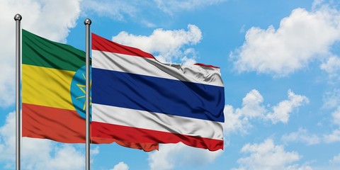 Ethiopia and Thailand flag waving in the wind against white cloudy blue sky together. Diplomacy concept, international relations.