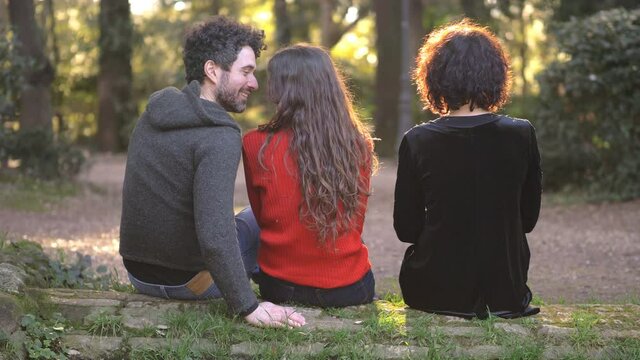 betrayal. man and woman flirting secretly from girlfriend in the park