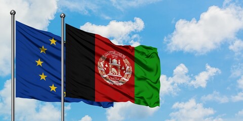 European Union and Afghanistan flag waving in the wind against white cloudy blue sky together. Diplomacy concept, international relations.