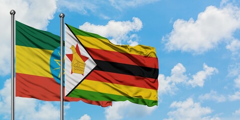 Ethiopia and Zimbabwe flag waving in the wind against white cloudy blue sky together. Diplomacy concept, international relations.