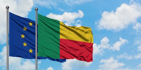European Union and Benin flag waving in the wind against white cloudy blue sky together. Diplomacy concept, international relations.