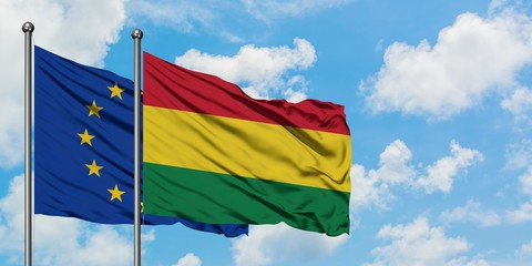 European Union and Bolivia flag waving in the wind against white cloudy blue sky together. Diplomacy concept, international relations.