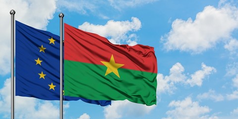 European Union and Burkina Faso flag waving in the wind against white cloudy blue sky together. Diplomacy concept, international relations.