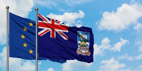 European Union and Falkland Islands flag waving in the wind against white cloudy blue sky together. Diplomacy concept, international relations.