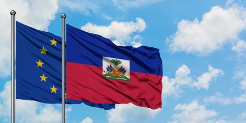 European Union and Haiti flag waving in the wind against white cloudy blue sky together. Diplomacy concept, international relations.