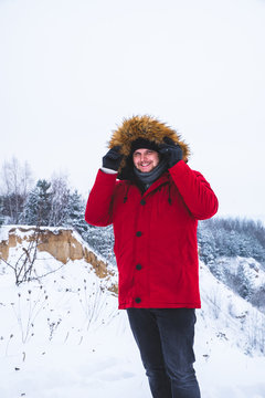 Man In Red Winter Coat With Fur Hood Snowed Field On Background