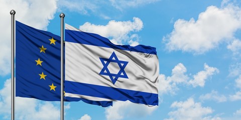 European Union and Israel flag waving in the wind against white cloudy blue sky together. Diplomacy concept, international relations.