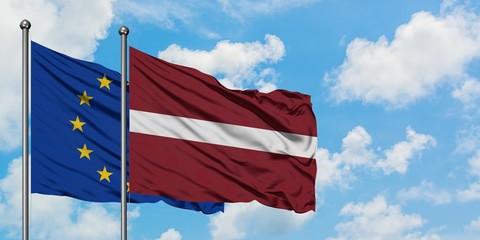 European Union and Latvia flag waving in the wind against white cloudy blue sky together. Diplomacy concept, international relations.