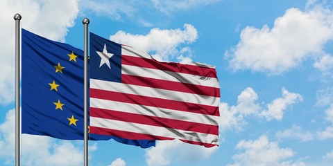 European Union and Liberia flag waving in the wind against white cloudy blue sky together. Diplomacy concept, international relations.