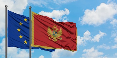 European Union and Montenegro flag waving in the wind against white cloudy blue sky together. Diplomacy concept, international relations.