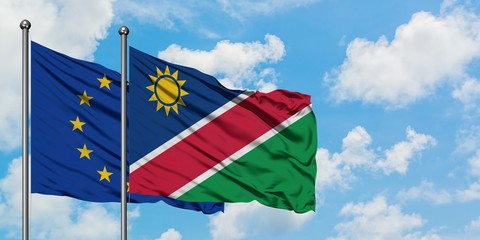 European Union and Namibia flag waving in the wind against white cloudy blue sky together. Diplomacy concept, international relations.