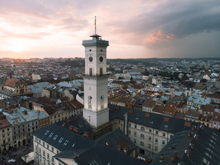 Fototapeta premium aerial view of lviv bell clock tower on sunset overcast sky