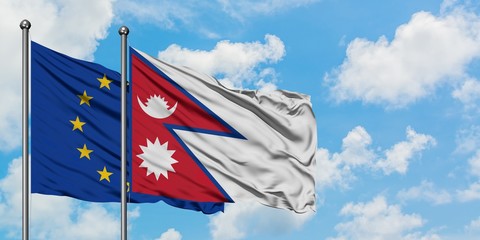 European Union and Nepal flag waving in the wind against white cloudy blue sky together. Diplomacy concept, international relations.