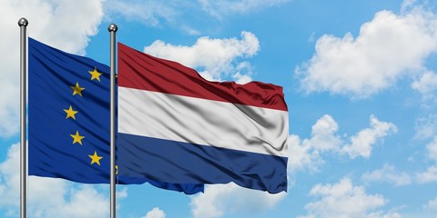 European Union and Netherlands flag waving in the wind against white cloudy blue sky together. Diplomacy concept, international relations.