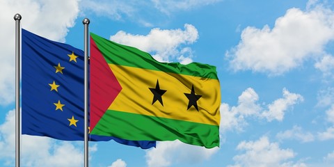 European Union and Sao Tome And Principe flag waving in the wind against white cloudy blue sky together. Diplomacy concept, international relations.