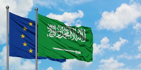 European Union and Saudi Arabia flag waving in the wind against white cloudy blue sky together. Diplomacy concept, international relations.