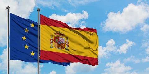 European Union and Spain flag waving in the wind against white cloudy blue sky together. Diplomacy concept, international relations.