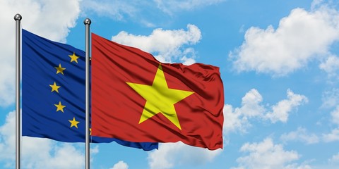European Union and Vietnam flag waving in the wind against white cloudy blue sky together. Diplomacy concept, international relations.